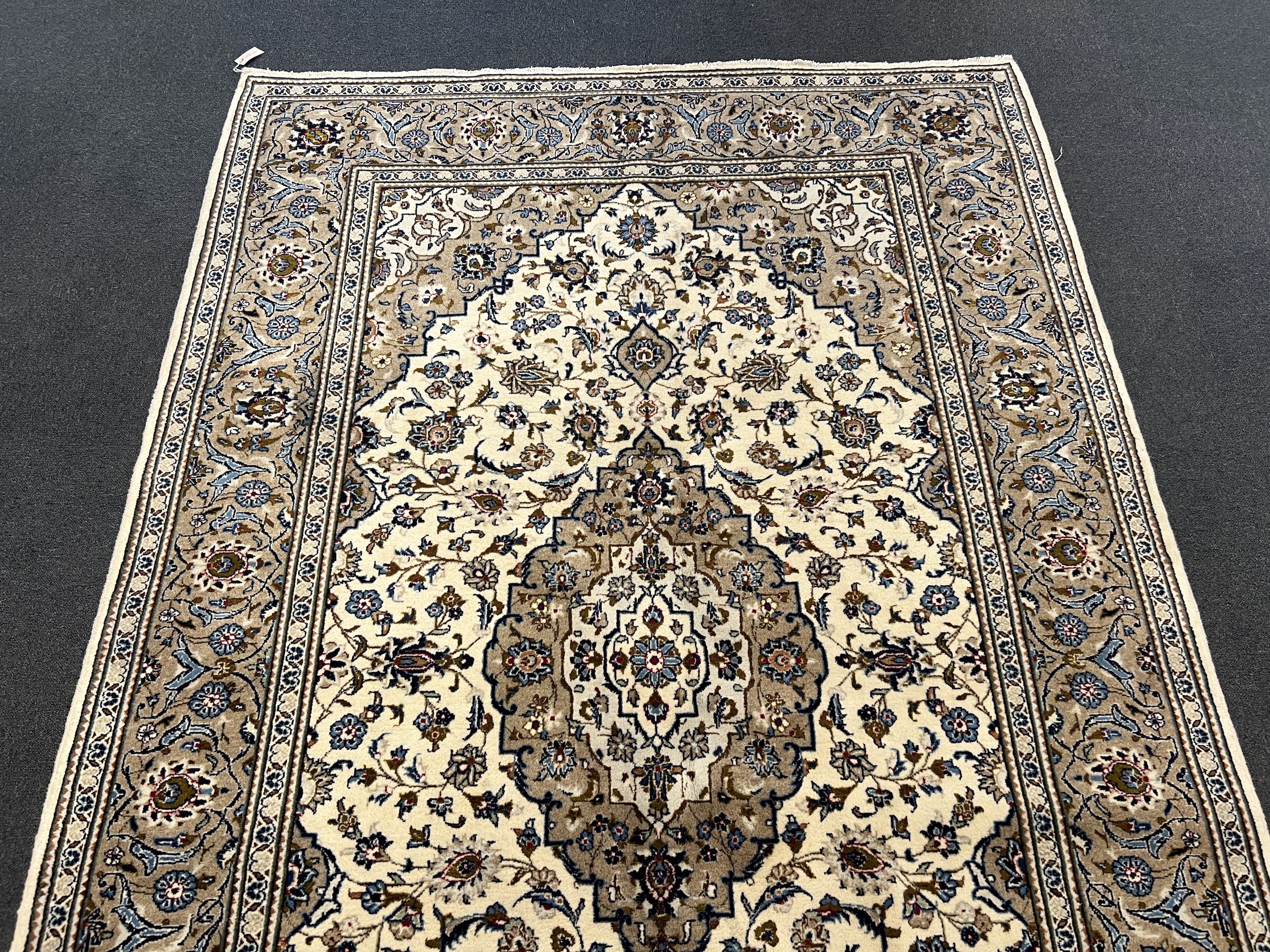 A Kashan ivory ground carpet